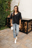 Nice Surprise Surplice Knit Top In Black